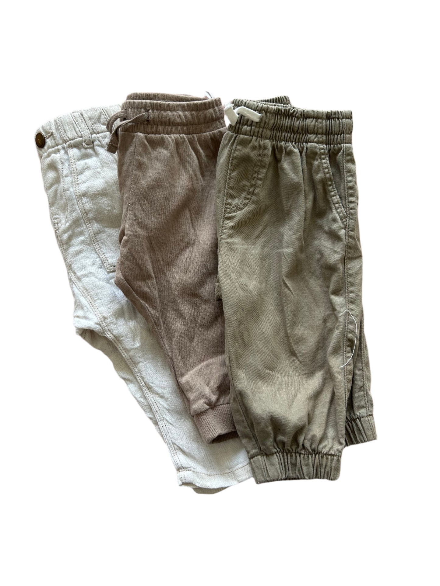 Folded pants on a pink bedspread
