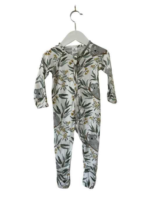 Baby onesie with animal and leaf pattern on a hanger against a white background