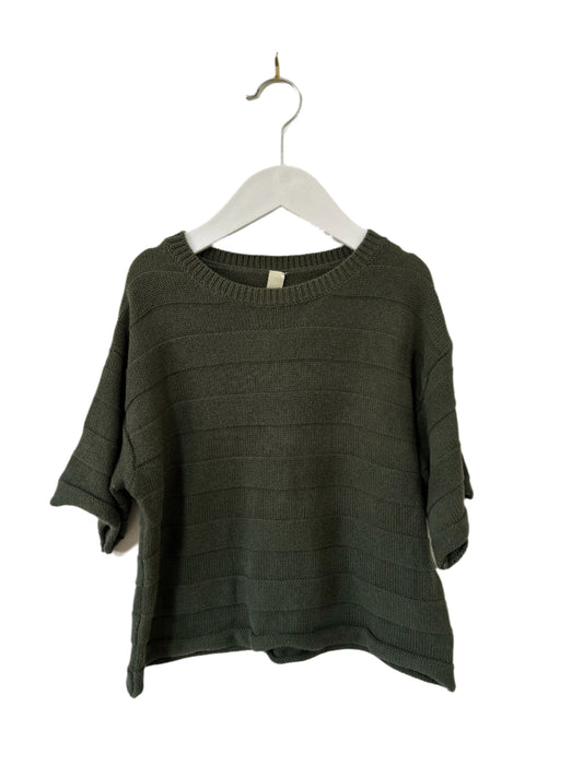 Green sweater on a hanger against a white background